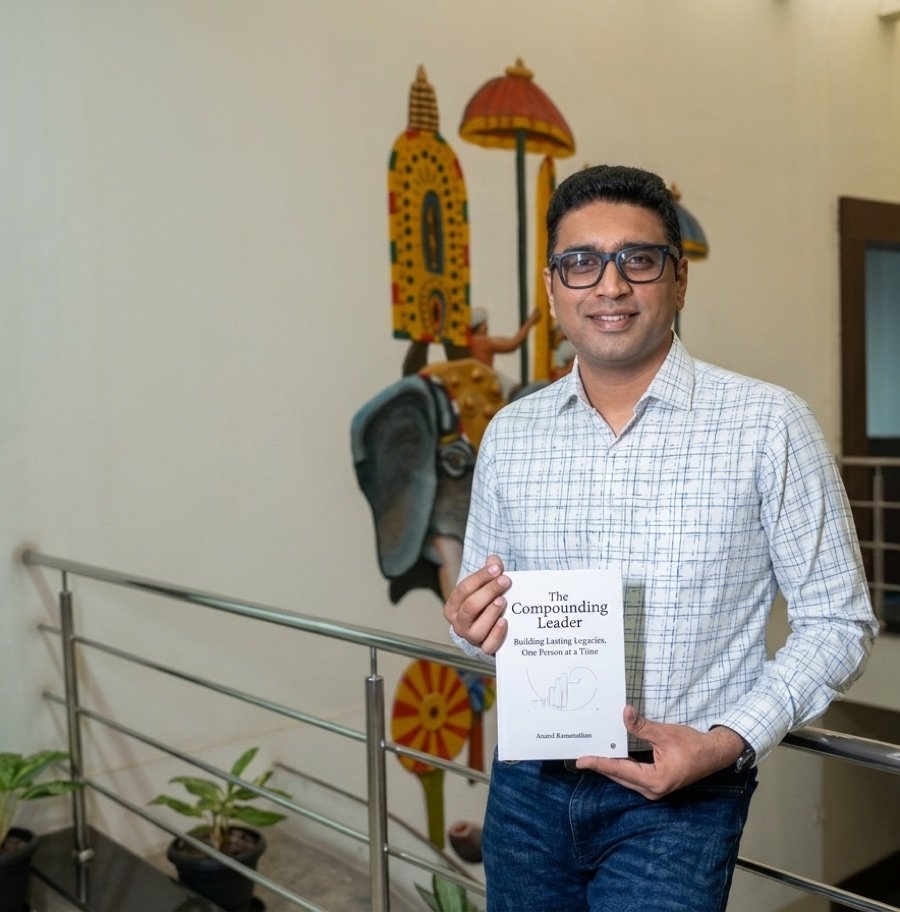 Adarsh Sudhindra holding The Compounding Leader